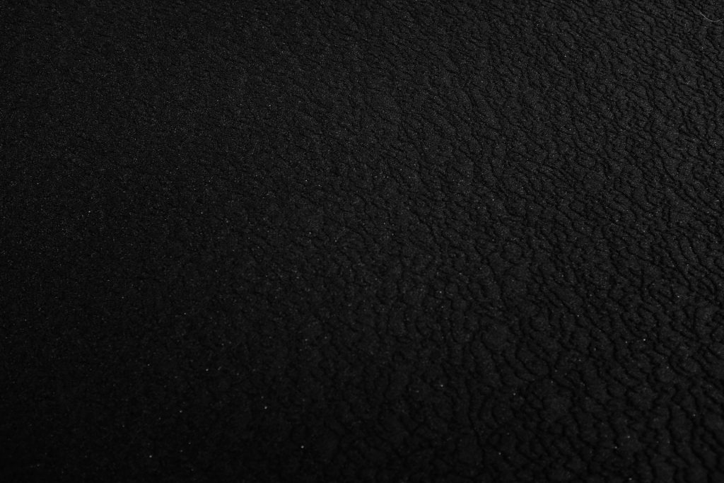 a black and white photo of a black surface